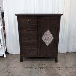 Dark Wood Five-Drawer Dresser with Ornate Panel