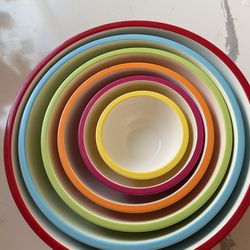 A set of colorful nested plastic bowls.