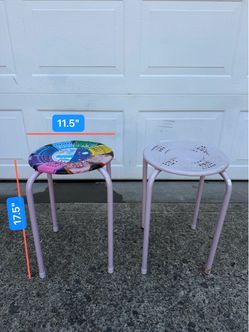 A pair of metal round stools