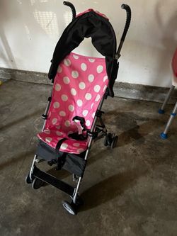 Disney Minnie Mouse themed umbrella stroller with a pink polka dot design