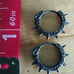 Gunmetal black hoop earrings with spikes and skulls