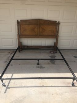 Vintage Wood Headboard with metal frame for a full mattress.