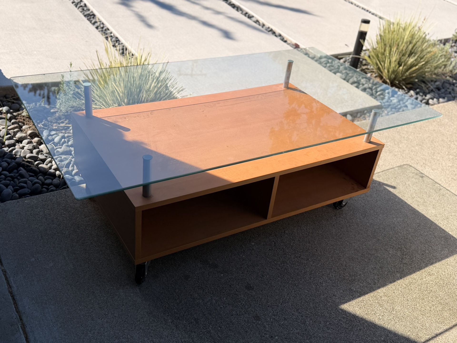 Wood and glass coffee table on rollers
