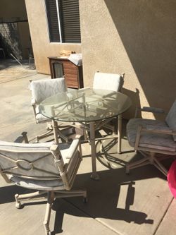 Glass table with rolling chairs