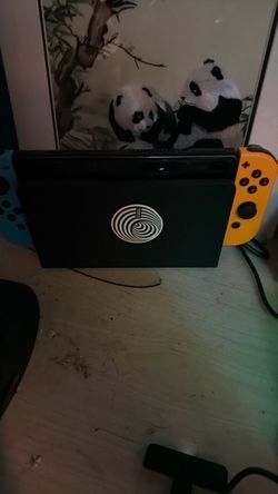 Nintendo switch oled with an extra set of controllers and a charging system