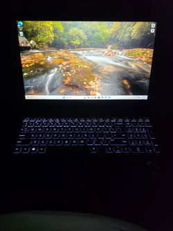 HP Envy X360 convertible touchpad laptop in dark gray with a backlit keyboard, Bang & Olufsen audio, AMD Ryzen 7 processor, and AMD Radeon graphics.