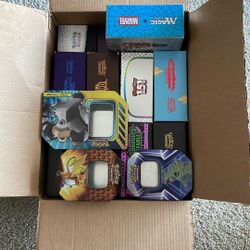 Box of empty Pokemon ETB Cases and Tins