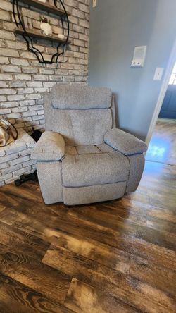 Cozy up in contemporary style. With super-plush fabric and padded arms,  rocker recliner levels up your day-to-day lounging