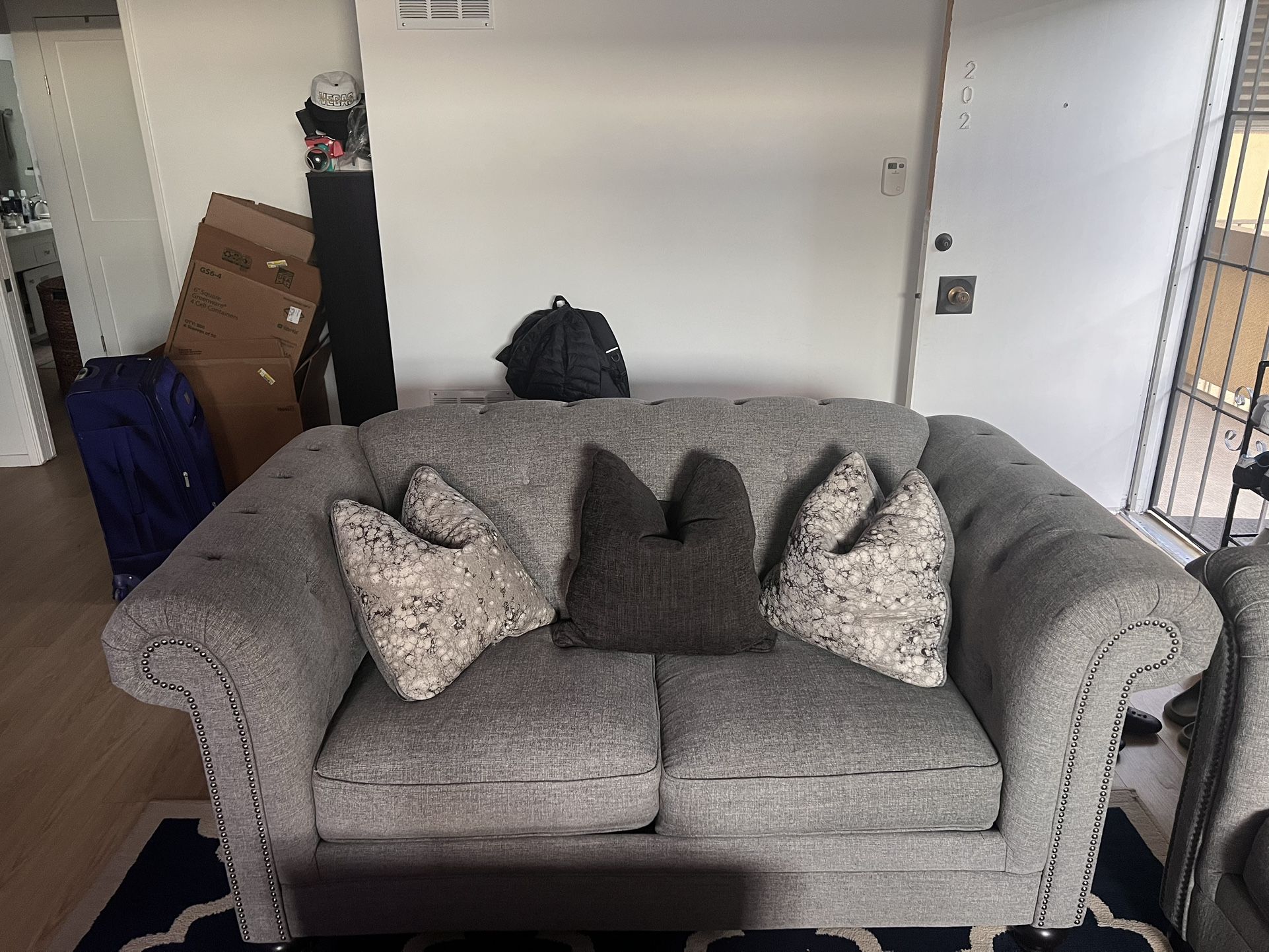Gray Tufted Sofa with Decorative Pillows