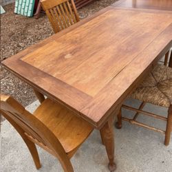 Table with Side Extensions, And Three Chairs 