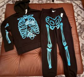 New Old Navy Skeleton black sweatshirt and sweatpants.  
 Size Children’s Large (10-12)