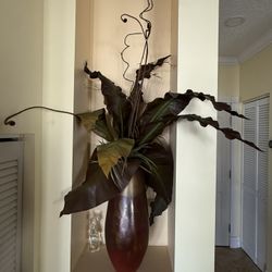 Vase with elephant ears plant leaves