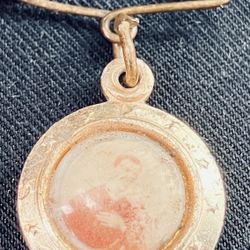 religious pin, specifically a "reliquia" (relic) pin dedicated to Saint Gerard Majella