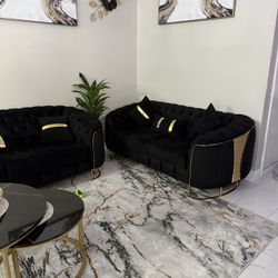 black and gold sofa and a set of tables