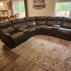 Gray leather sectional couch with 3 recliners