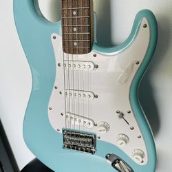 Fender Squire strat New still has the plastic on her. With gig bag perfect gift or first guitar great color mint. Who ever buy it can remove the plast