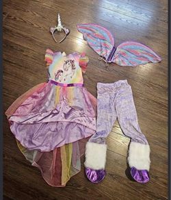 Girl unicorn dress size 6 muticolor rainbow unicorn Halloween dress w/ decor  Washed with detergent and sanitizer  Dressed twice  Comes from pet free 