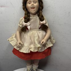 This is a collectible porcelain doll "Check Up" from the Norman Rockwell collection.