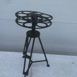 DecMode 15" x 25"  Metal Reel Film Accent Table with Tripod Legs. No  Glass Top, 1-Piece location below  31705 Wesley Chapel blvd Fl 33543 Storage Mar