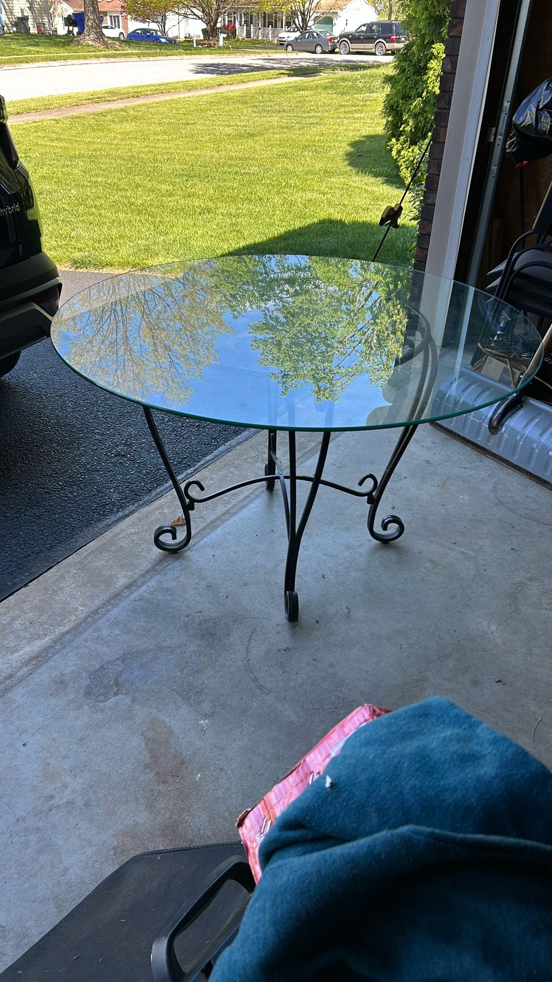 Must Sell Make Reasonable Offer New condition, 48 inch round grass top with iron base and one chair of four with new cushions shown in photo