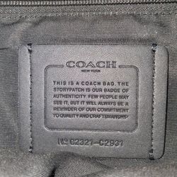 This is a black Coach Graham Pack sling bag, a versatile leather