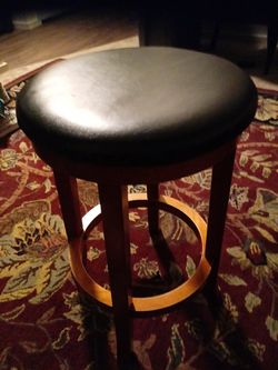Black leather top wooden swivelling bar stool