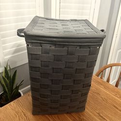 $10 - Stylish Bombay Heritage laundry hamper. Brown woven exterior with a cool patterned fabric lining inside. Has a lid and handles for easy moving. 