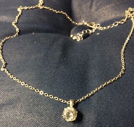 Silver tone necklace with 3/10" clear stone
