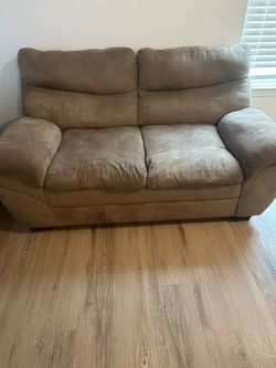 Tan Loveseat with a side table