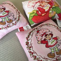 Three vintage strawberry shortcake throw pillows