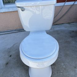 Toilet in good, clean condition; measures 16 inches in height.