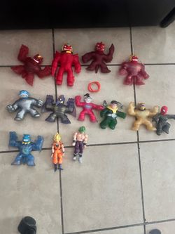 Goo jit zus and two Goku action figures