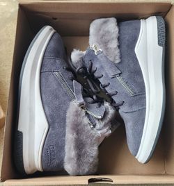 New Cloud Nine Sheepskin Randi sneakers are gray suede with a genuine sheepskin lining. These shoes have a lace-up front, side zipper closures, and a