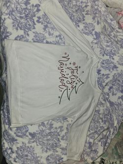 Cream holiday pullovers featuring festive script and graphic designs