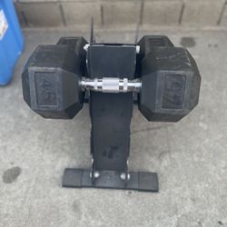 Set pair of 45-pound each rubber-coated hexagonal dumbbells. With Stand