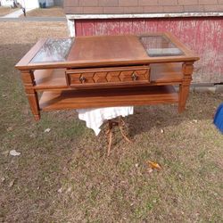 Solid wood coffee table with glass pops.
