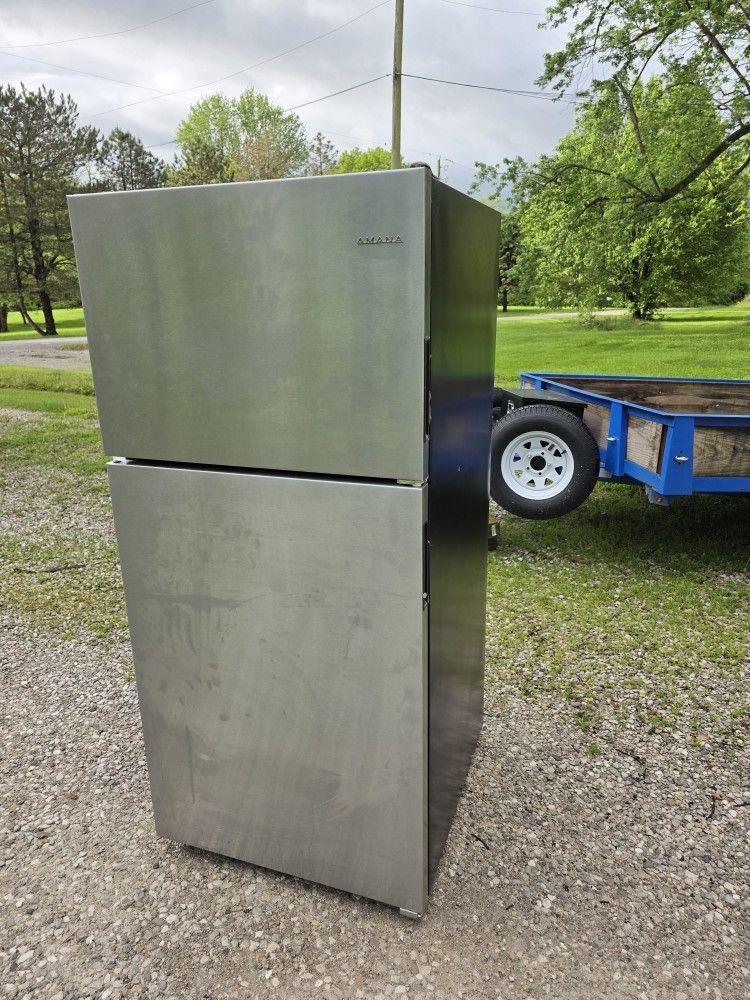 Aman at a stainless steel refrigerator