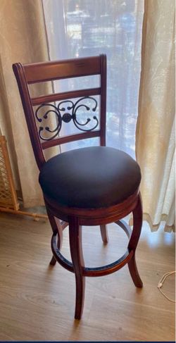 Brown wood stool with black seat