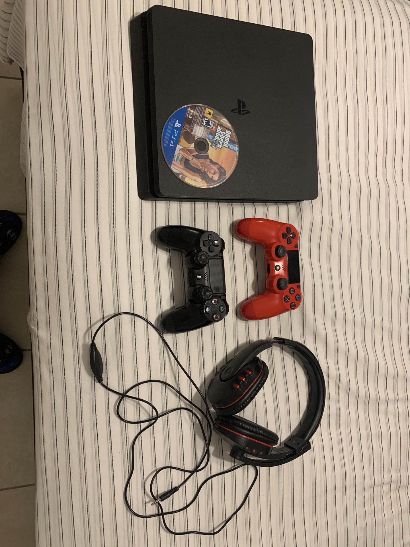 Black Ps4 with 2 controllers, headset, and gta