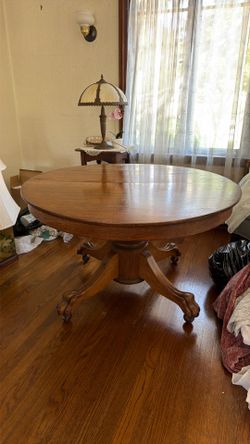 Round claw foot oak dining table