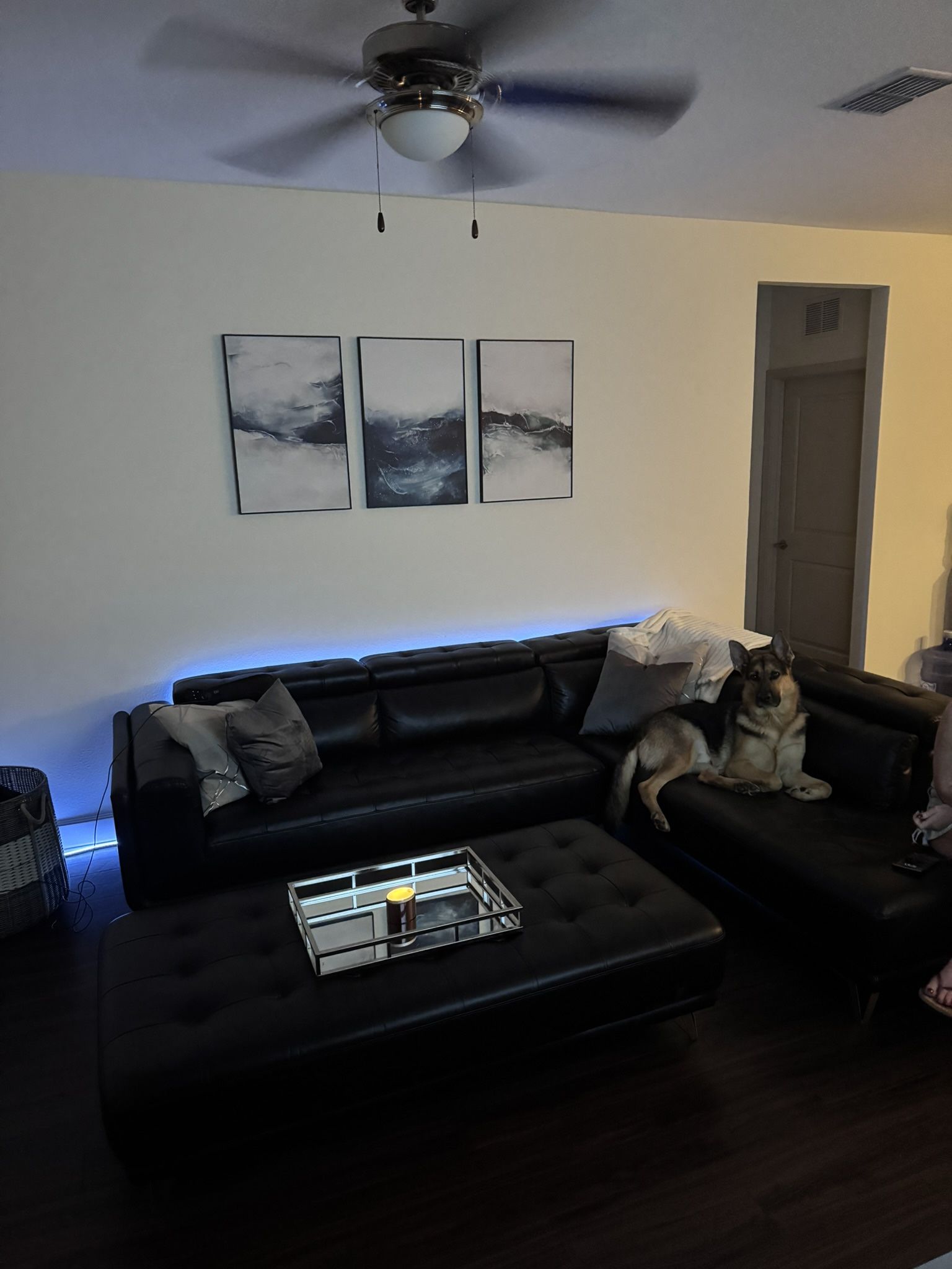 black leather sectional with ottoman .
