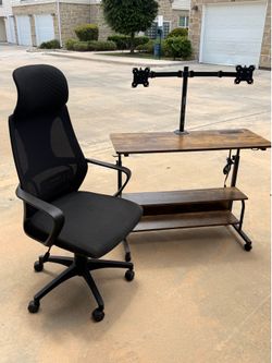 Dual monitor desk with plugs and a chair