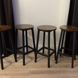 Four (4) 26” bar stools. Rustic black & brown.