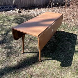 antique wooden drop-leaf dining table