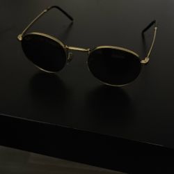 Legend, gold Ray-Ban’s with green lens