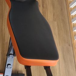 Adjustable weight bench with orange and black padding
