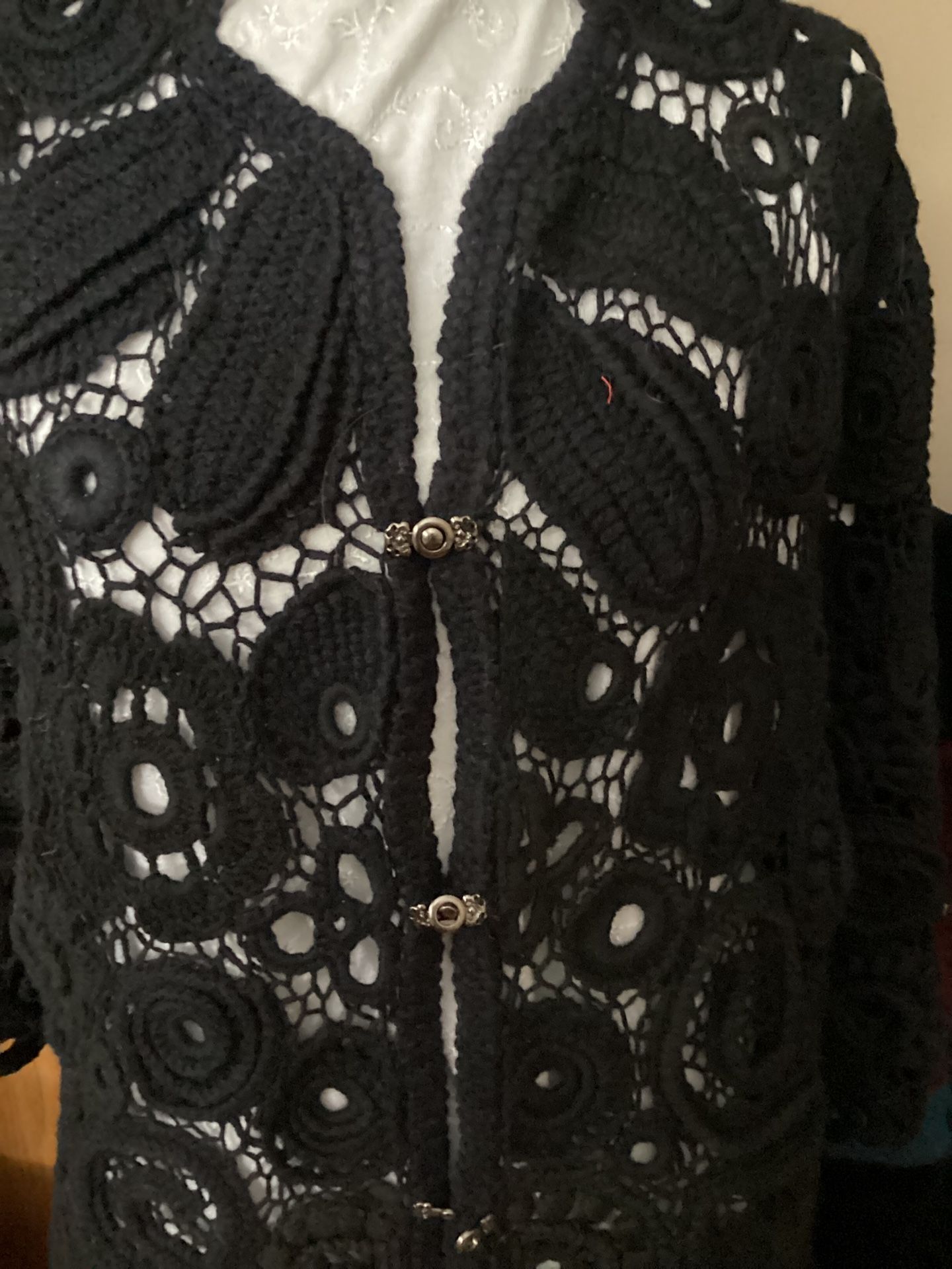 A Black Crochet Cardigan With Irish Lace Is Very Elegantly 