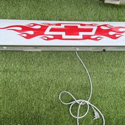 Light up Chevy sign with blue bell logo in the back