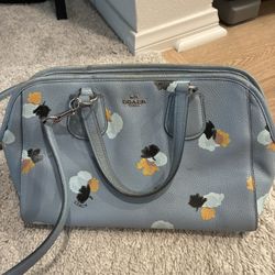 Blue Coach handbag & matching wristlet with floral design.