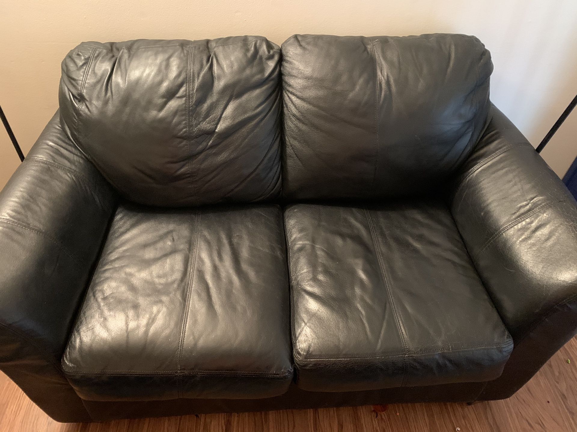 Black leather love seat